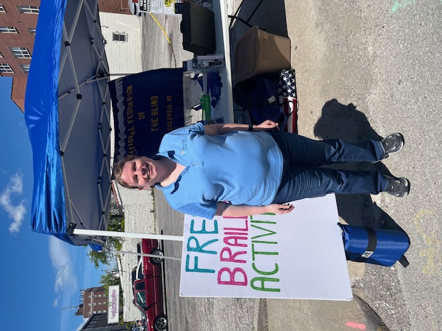 Dacia Cole standing at our 2025 Earth Day table